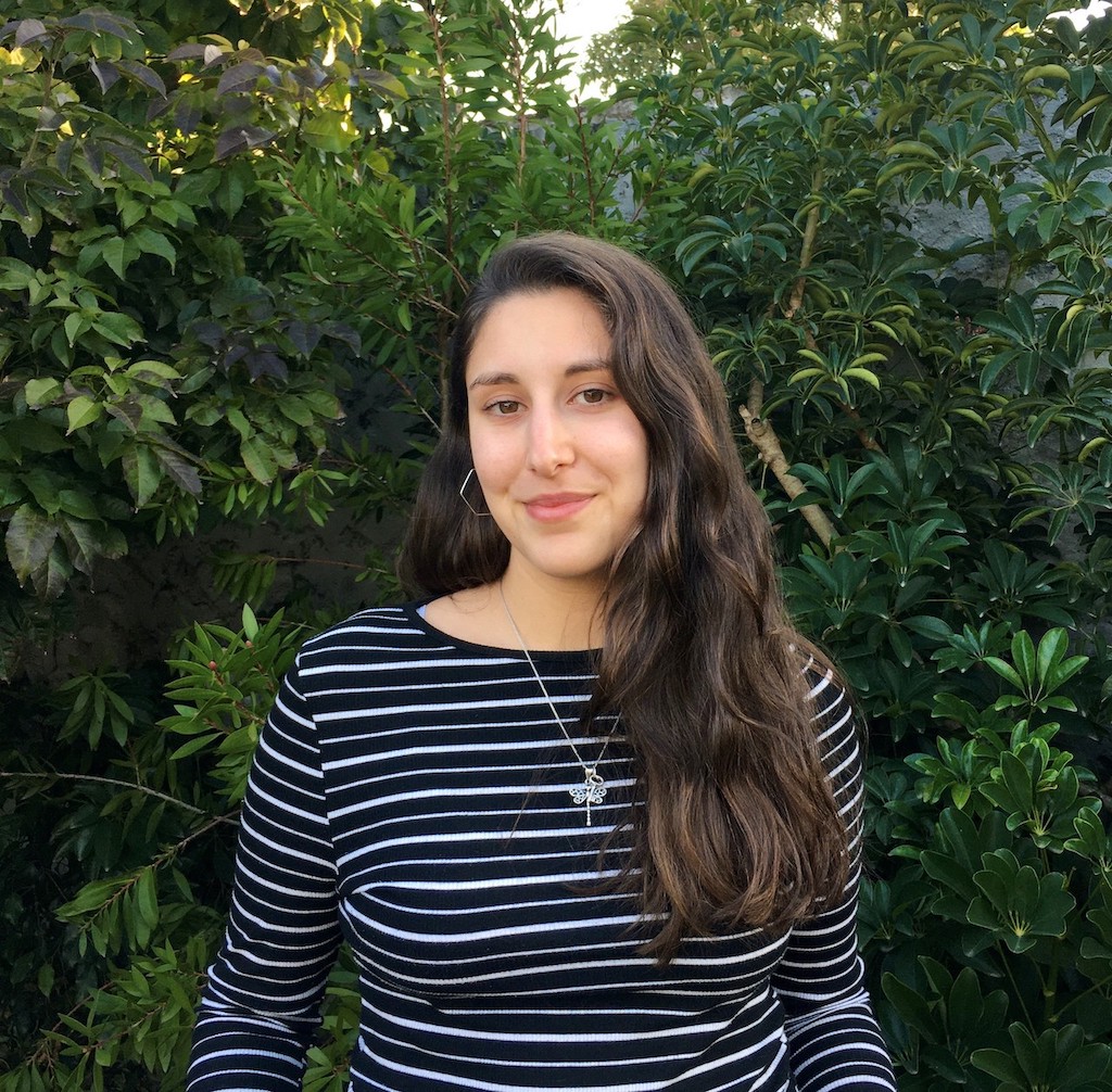 young woman in front of tree