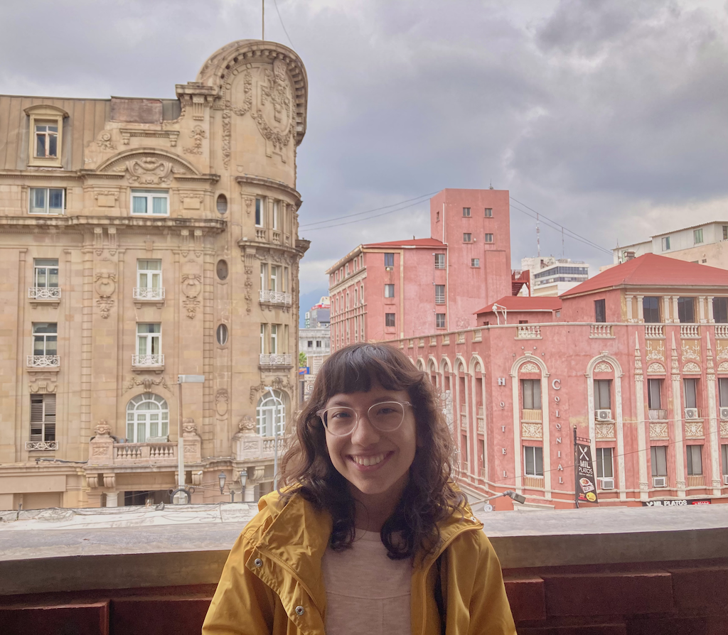 young woman in front of big buildings