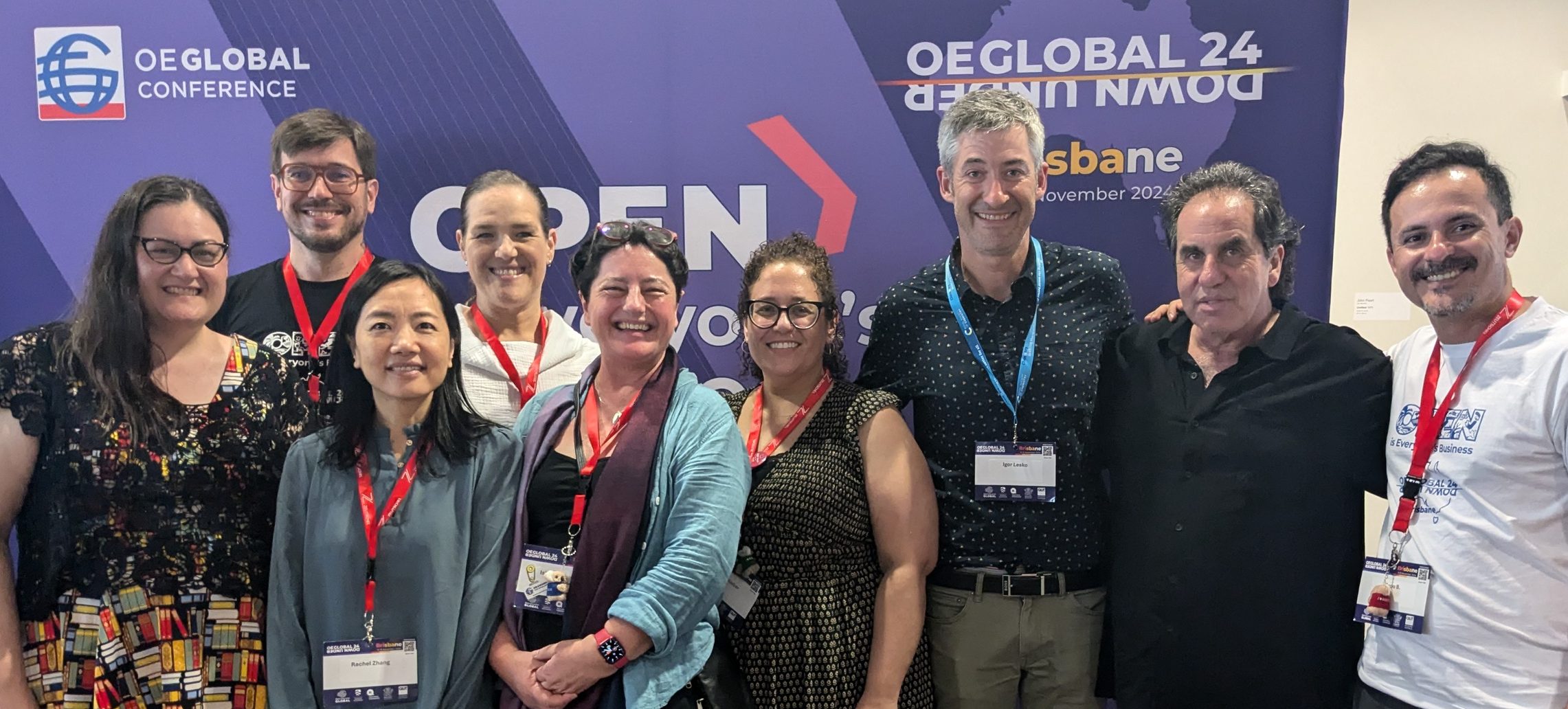 A group of people in front of a banner