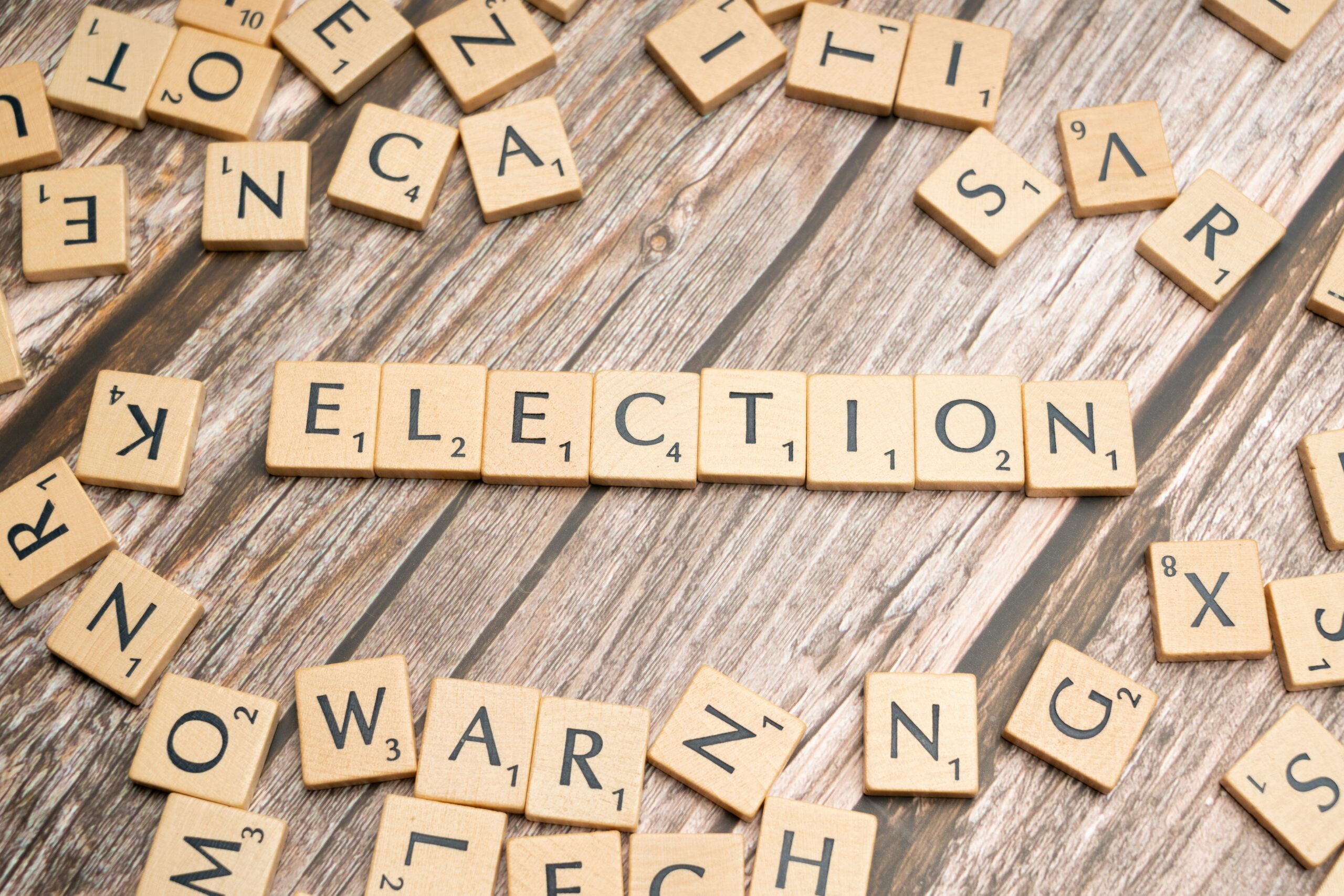 Scrabble pieces on a wood surface make up the word "Election" Photo by Markus Winkler on Unsplash